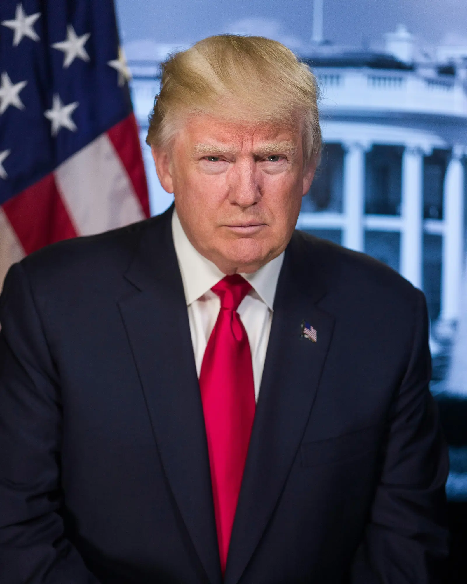Donald Trump in a dark suit and red tie, with a United States flag and the White House behind him.